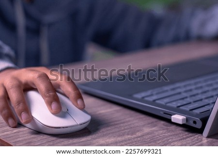 The girl's hand sat on the computer.