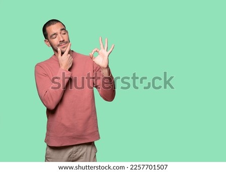 Worried young man doubting and making a gesture of approval