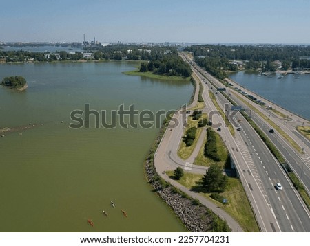 Aerial view of Finnish national main road 51 and helsinki city. Marina and paddlers also in the picture.