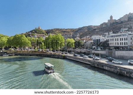 Scenic view of the Kura (Mtkvari) River in Old Town of Tbilisi, Georgia. Tbilisi is a popular tourist destination of the Caucasus region. Royalty-Free Stock Photo #2257726173