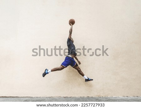African american basketball player training on a court in New York - Sportive man playing basket outdoors