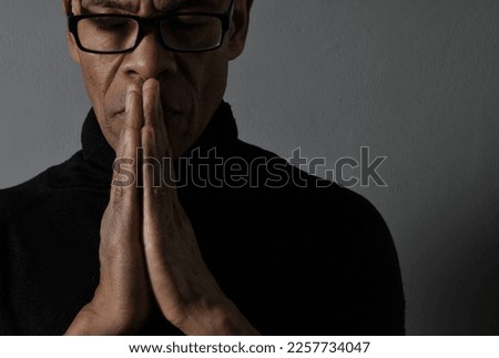 people praying to god at home on black background with people stock photo	