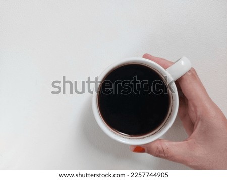 A cup of black coffee on white porcelain cup. Coffee time photography concept. Isolated background in white