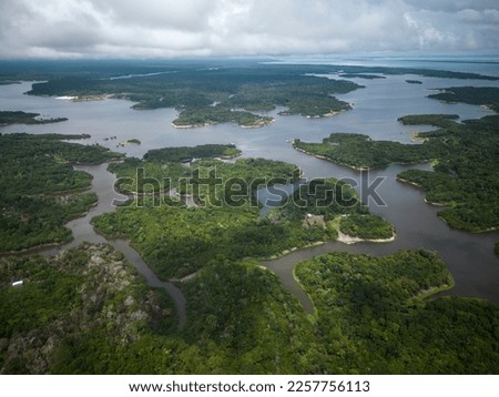 Beautiful aerial drone view to large rivers and green rainforest in the Brazilian Amazon