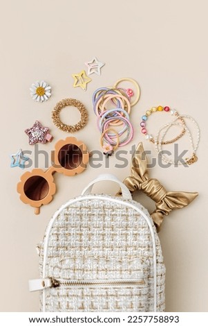 Fashion backpack with sunglasses, kids jewelry and hair accessories. Baby girl stuff and  accessory.  