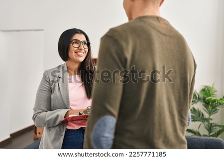 Man and woman having psychology session standing at clinic Royalty-Free Stock Photo #2257771185