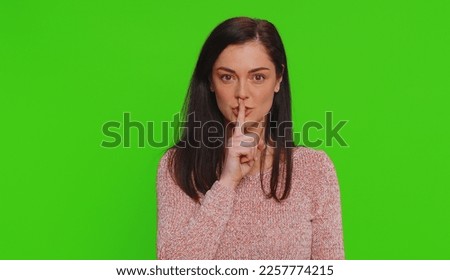 Shh be quiet please. Portrait of millennial woman 30 years old presses index finger to lips makes silence gesture sign do not tells secret. Young lovely pretty girl posing on chroma key background