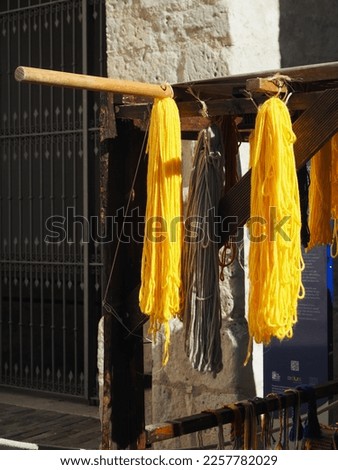 colored wool hanging, yellow predominates