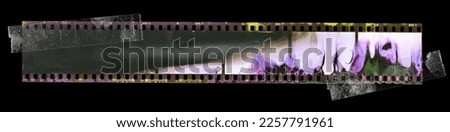 dark 35mm filmstrip isolated on black with developing smear marks fixed by two transparent sticker.