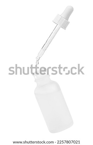 White cosmetic glass jar. Pipette with dripping outflowing liquid into a jar. Isolated on white background. Hyaluronic acid. Serum for the face. Hydration. Royalty-Free Stock Photo #2257807021