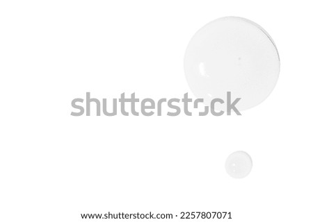 large drops of transparent gel or serum or water, on a white background, top view, isolated Royalty-Free Stock Photo #2257807071