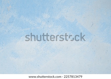 Blue background, cracked wall, covered with multi-layer paint. fragments of chipped plaster from the wall. Interesting texture overlay. Space for copy. Copy space. Old blue Grunge Abstract Background.