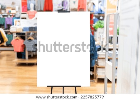 Mockup vertical advertising signboard on stand at front of clothing shop, empty space for insert your text, announcement or advertisement promotion