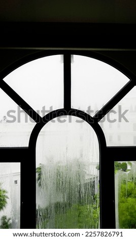 Arch window with raining dripping down                                