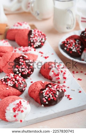 Valentines day cookies. Shortbread cookies with glaze white and dark chocolate and heart sprinkles on plate on white background. Mothers day. Womans day. Sweet holidays baking. Top view.