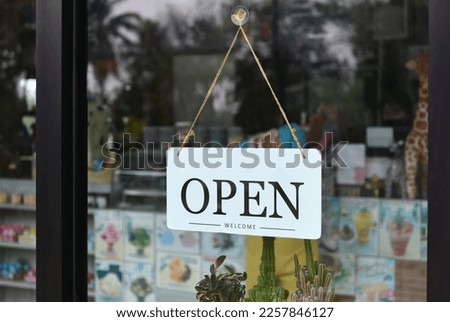 OPEN sign board at front op shop glass wall