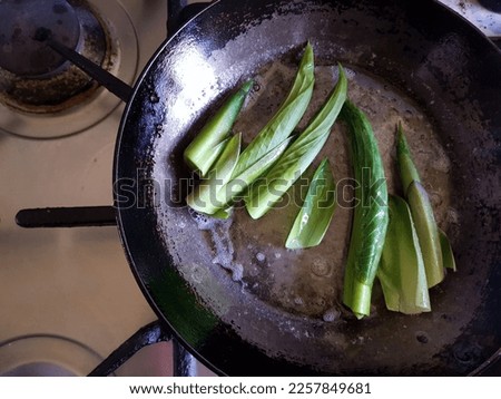 Cooking and eating delicious hosta shoots Royalty-Free Stock Photo #2257849681