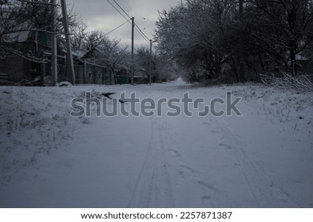 Winter landscape with country road covered with snow in Ivashkove village, Dniproperovsk oblast, Ukraine 