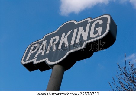 An image of a parking sign with blue sky