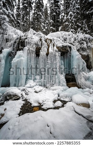 A frozen waterfalls is one of the attraction to see in Maligne canyon ice walk during the winter. Jasper National Park is home for impressive winter activities you can enjoy. Royalty-Free Stock Photo #2257885355