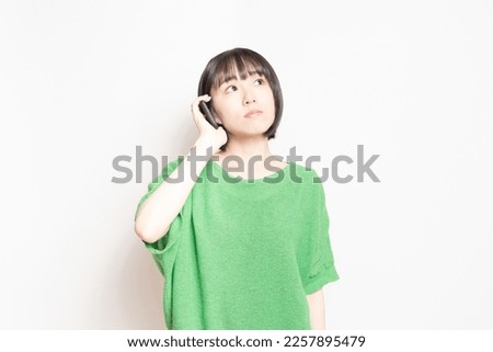 Young woman operating a cell phone