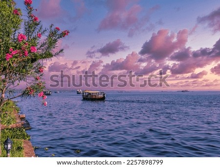 Beautiful landscape with a house boating in marine drive, Kochi, India. Travel and tourism Kerala - houseboat on Alleppey backwaters in India. Kerala houseboat image. High quality photo Royalty-Free Stock Photo #2257898799