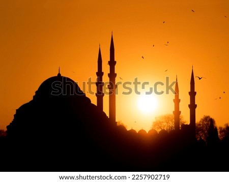 Suleymaniye Mosque silhouette, one of the unique symbols of Istanbul, at sunset. Ramadan themed iftar and evening prayer.