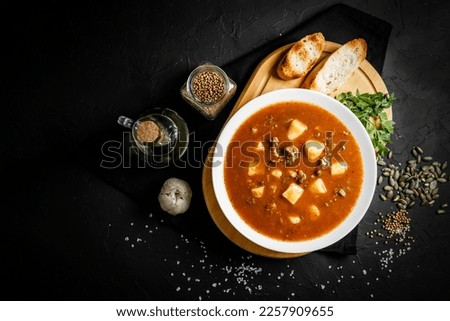 Bograch - Hungarian soup goulash with meat and vegetables. Traditional Hungarian goulash soup with stew and paprika. Prepared in a cauldron over a fire. Bograch. Royalty-Free Stock Photo #2257909655