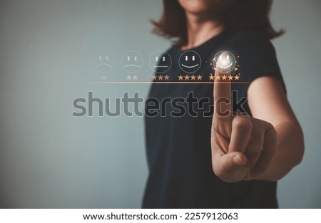 Customer service evaluation concept. Businesswoman pressing smile face emoticon on the virtual touch screen. customer service and five stars satisfaction rating. Royalty-Free Stock Photo #2257912063