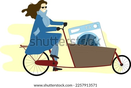 Young woman brown hair riding bakfiets cargo bike on a high speed. City family bicycle with front box trunk and large cargo in it concept.