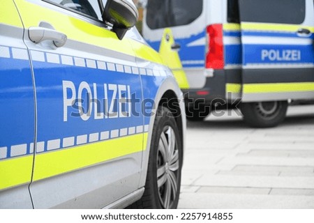 German police car on the street. Side view of a police car with the lettering "Polizei".  Police patrol car parked on the street in Germany. Royalty-Free Stock Photo #2257914855