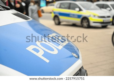 German police car on the street. Side view of a police car with the lettering "Polizei".  Police patrol car parked on the street in Germany. Royalty-Free Stock Photo #2257915751