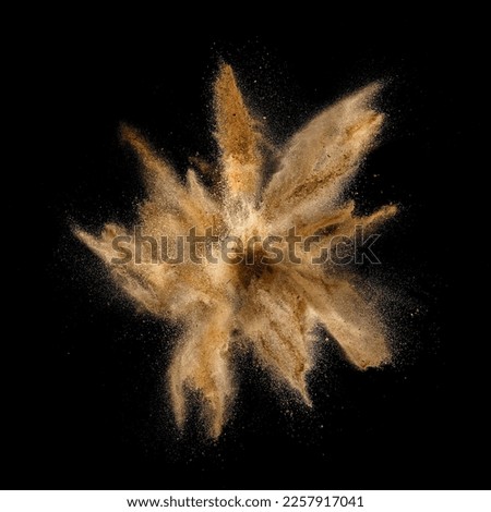 Golden fine sand explosion, top view on black background Royalty-Free Stock Photo #2257917041