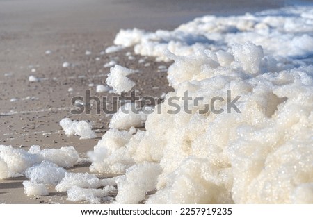 foam from some waves at the lonely beach