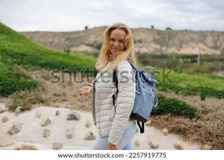 Portrait of a tourist woman against the background of nature