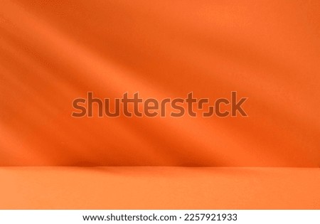 Bright orange background with plant shadows for product or cosmetics. High quality photo Royalty-Free Stock Photo #2257921933