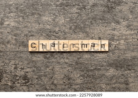 CHAIRMAN word written on wood block. CHAIRMAN text on cement table for your desing, concept. Royalty-Free Stock Photo #2257928089