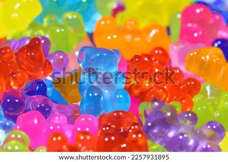 Pile of brightly lit gummy bear sweets. Shallow depth of field, central focus. Royalty-Free Stock Photo #2257931895