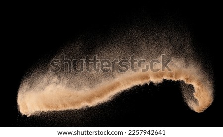 Small size fine Sand flying explosion, Golden grain wave explode. Abstract cloud fly. Yellow colored sand splash silica in Air, Galaxy star universe sign symbol. Element Black background Isolated Royalty-Free Stock Photo #2257942641