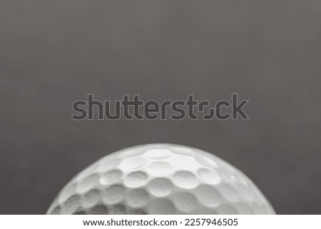 Close up of white golf ball with copy space on grey background. Golf, sports and competition concept.