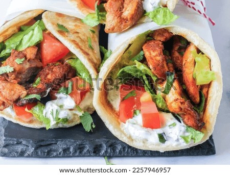 This is Arabic style shawarma...This is same recipe of shawarma which you eat in Saudi Arab streets...It is made of Khubz ,flavorful marinated chicken, crunchy salad and yogurt dip.