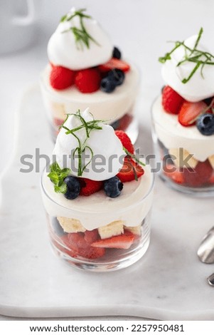 Berry pound cake trifle or parfait with cream cheese mousse and whipped cream, dessert in a glass idea