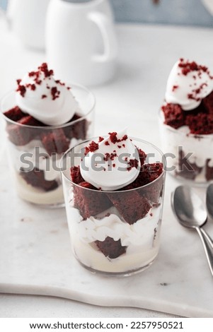 Red velvet trifle or parfait with cream cheese mousse and whipped cream, dessert in a glass idea Royalty-Free Stock Photo #2257950521