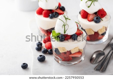 Berry pound cake trifle or parfait with cream cheese mousse and whipped cream, dessert in a glass idea