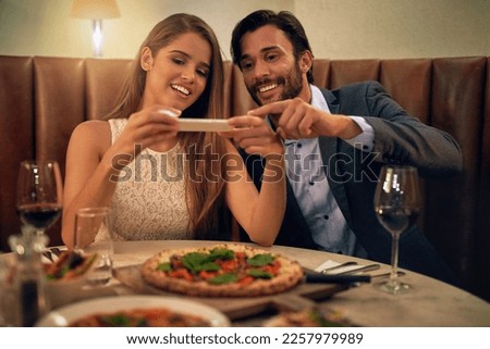 Restaurant, couple and phone for photo of food, pizza or romantic date night meal for valentines day. Social media, picture and influencer man with woman on smartphone for blog, review or eating post