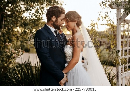 Wedding, love and bride with groom in garden for marriage, ceremony celebration and commitment. Romantic partners, trust and bridal couple hug, embrace and happy for romance, calm and peace in park Royalty-Free Stock Photo #2257980015