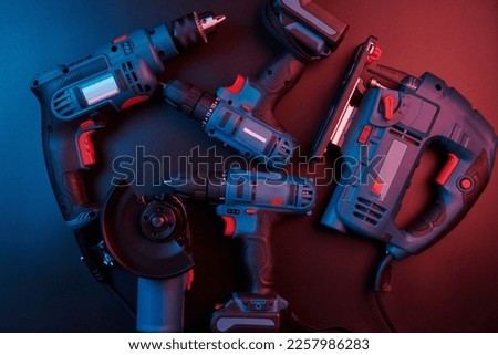 Set of new power tools isolated on a black background, drill, puncher, electric saw, jigsaw, circular saw Royalty-Free Stock Photo #2257986283
