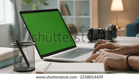 A freelancer has a video chat with employer, gesturing. Remote worker using his chroma key green screen laptop for online conference - connection, technology concept 
