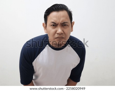Confused asian man looking to camera with curiosity, close up portrait facial expression against white bacground Royalty-Free Stock Photo #2258020949