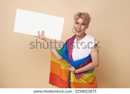 Happy asian transgender LGBT hand showing blank announcement banner isolated on studio background.